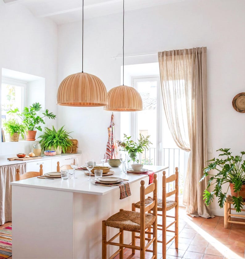Maple wood pendant light Bell Maple Scandinavian ceiling lamp hanging above dining table with warm glow