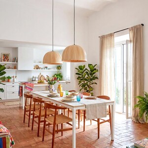 Maple wood pendant light Bell Maple Scandinavian ceiling lamp hanging above dining table with warm glow
