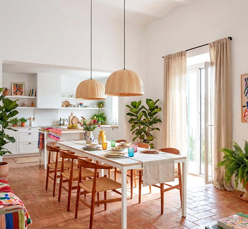 Maple wood pendant light Bell Maple Scandinavian ceiling lamp hanging above dining table with warm glow
