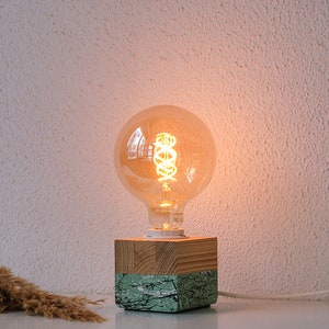 An Edison table lamp which highlights the natural beauty of each individual unique wood. Handmade wooden table lamps are one of interior decor favorites, as they add to the main lighting and add style to interior decoration.