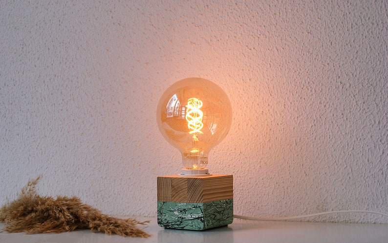 An Edison table lamp which highlights the natural beauty of each individual unique wood. Handmade wooden table lamps are one of interior decor favorites, as they add to the main lighting and add style to interior decoration.