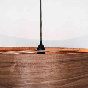 Wood pendant light made of walnut wood perfect for your bedroom or living room. The right choice of modern chandelier will give your space the aura you desire
