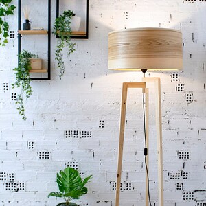 Handmade Wooden Floor Lamp with tripod base and natural wooden shade. A modern wooden floor lamp is the detail that will alter your homes mood.