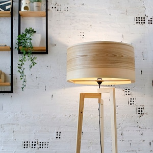 Handmade Wooden Floor Lamp with tripod base and natural wooden shade. A modern wooden floor lamp is the detail that will alter your homes mood.