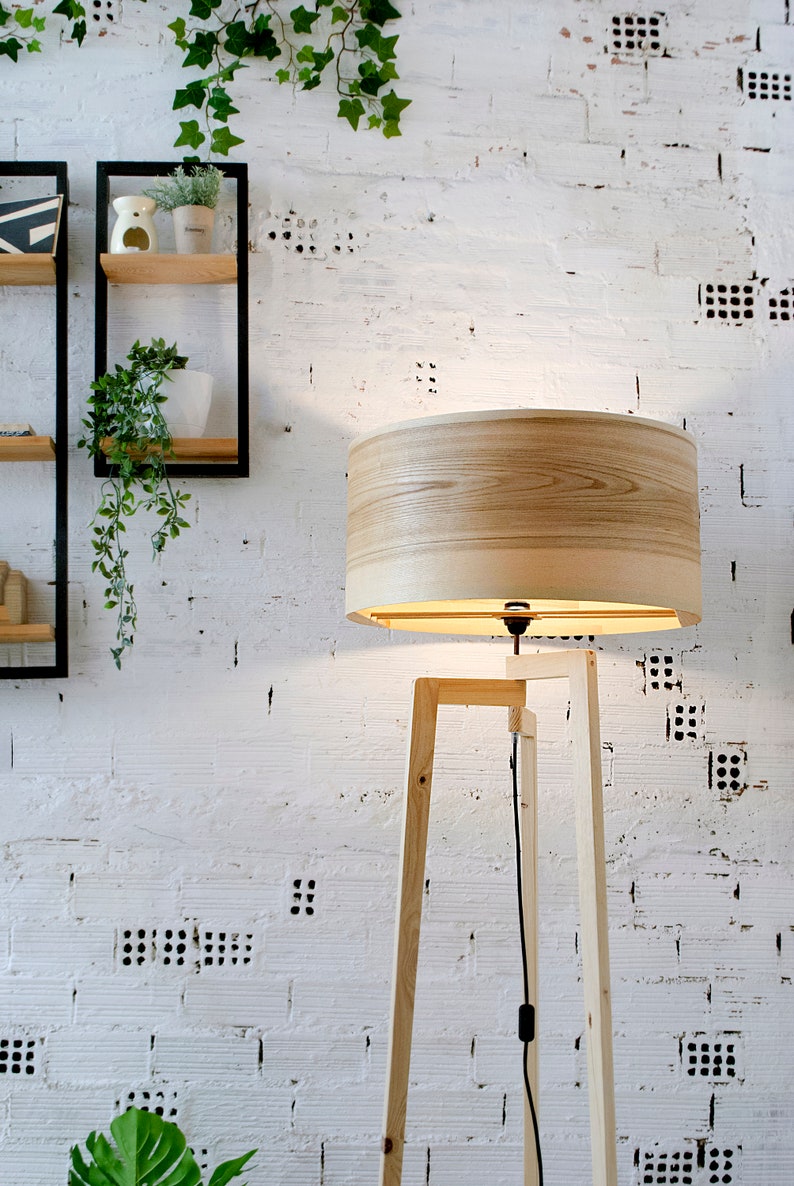 Handmade Wooden Floor Lamp with tripod base and natural wooden shade. A modern wooden floor lamp is the detail that will alter your homes mood.