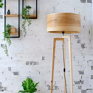 Handmade Wooden Floor Lamp with tripod base and natural wooden shade. A modern wooden floor lamp is the detail that will alter your homes mood.