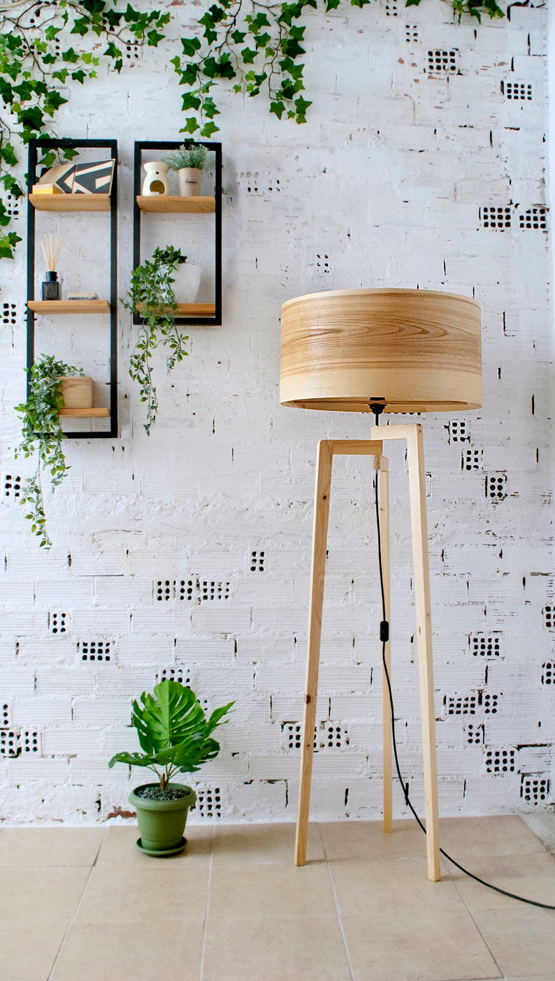 Handmade Wooden Floor Lamp with tripod base and natural wooden shade. A modern wooden floor lamp is the detail that will alter your homes mood.