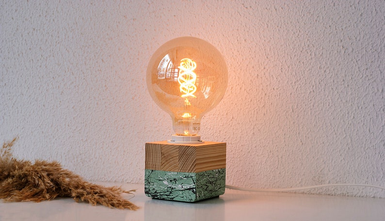 An Edison table lamp which highlights the natural beauty of each individual unique wood. Handmade wooden table lamps are one of interior decor favorites, as they add to the main lighting and add style to interior decoration.