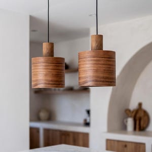 Wood pendant light made of walnut wood perfect for your kitchen or dining room. The right choice of modern chandelier will give your space the aura you desire