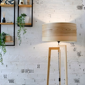 Handmade Wooden Floor Lamp with tripod base and natural wooden shade. A modern wooden floor lamp is the detail that will alter your homes mood.
