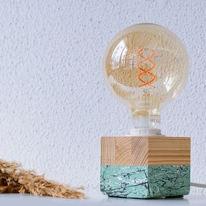 An Edison table lamp which highlights the natural beauty of each individual unique wood. Handmade wooden table lamps are one of interior decor favorites, as they add to the main lighting and add style to interior decoration.