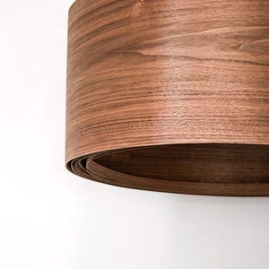 Wood pendant light made of walnut wood perfect for your bedroom or living room. The right choice of modern chandelier will give your space the aura you desire