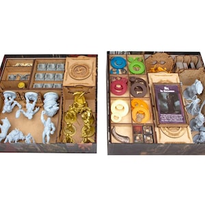 May include: Two rectangular board game storage organizers made of light brown wood. The left box contains gray and gold plastic miniature figures. The right box features colorful circular tokens, card decks, and additional gray miniature figures.