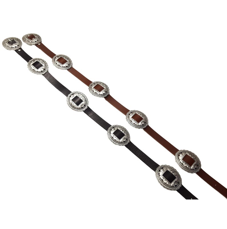 May include: Two leather belts with decorative silver-toned oval buckles. One belt is black, and the other is brown. The buckles have a square center design. The belts are displayed against a white background.