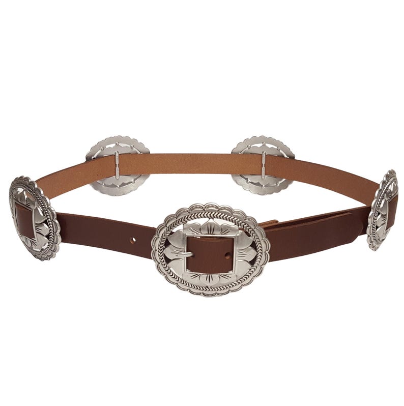 May include: A brown leather belt with silver-colored decorative buckles. The belt has a series of round and oval buckles with intricate designs. The belt is a western-style accessory.