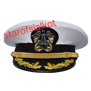 May include: A white naval officer's hat with a black band and gold accents. The hat features a gold emblem with an eagle and a shield. The brim is white, and the hat has gold trim around the black band. The text "starofsialkot" is printed on the hat.