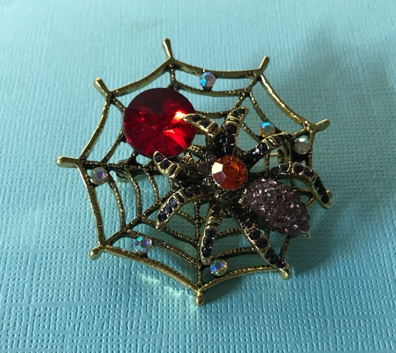 Rhinestone spider pin, spider in web, red rhinesto