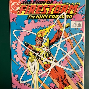 May include: A set of three ceramic mugs with a speckled, matte finish. The mugs are in shades of cream, light gray, and dark gray. Each mug has a simple, minimalist design and a rounded handle. The mugs are likely for coffee or tea.