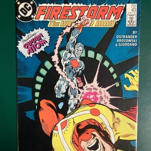 May include: A vintage comic book titled "Firestorm" featuring Captain Atom. The cover art depicts a superhero in a silver and red suit, with a burst of energy. The comic is issue #63, dated September 1987, with the DC Comics logo.