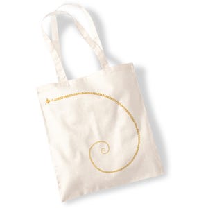 May include: A white canvas tote bag with a gold spiral design. The spiral is made up of the digits of the golden ratio, "Φ = 1.6180339887498948482045868343656381177203091798057628621354486227..."