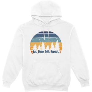 May include: A white hooded sweatshirt featuring a graphic of a sunset with horizontal stripes in navy, light blue, and orange. Below the sunset, white silhouettes of pine trees are visible, with the text Eat. Sleep. Drill. Repeat. in navy.