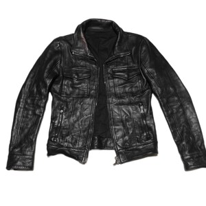 May include: A black leather jacket with a zipper closure and multiple pockets.