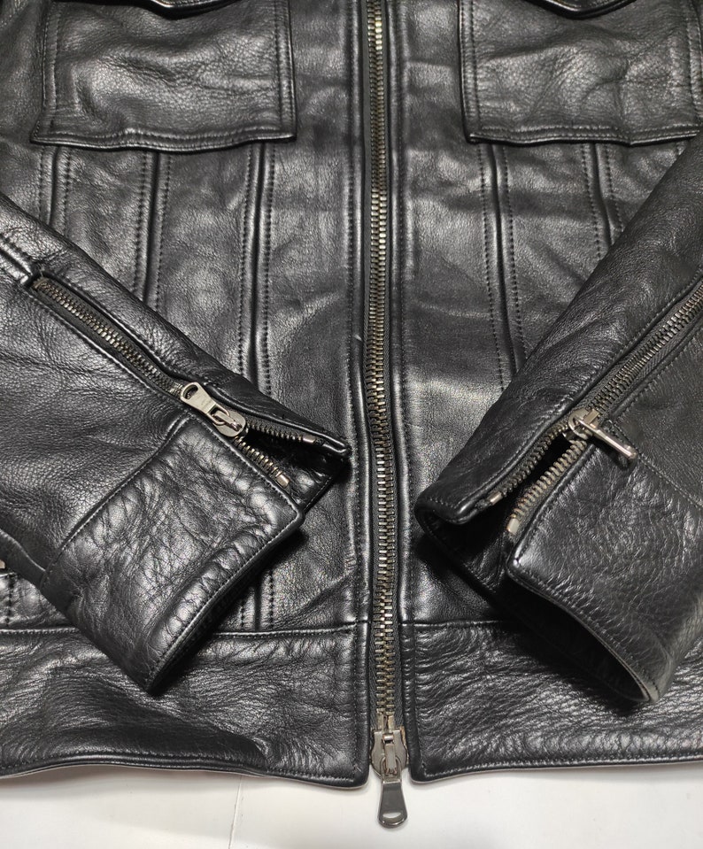 May include: Black leather jacket with a zipper closure and two zippered pockets on the sleeves.