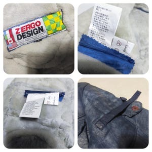 Op de afbeelding: Close-up shots van een ZERGO DESIGN jas. De jas heeft een blauwe leren buitenkant met een knoopsluiting en een zachte, lichtgekleurde binnenkant. Labels met tekst en wasvoorschriften zijn zichtbaar.