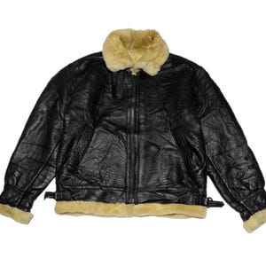 May include: A black leather bomber jacket with a shearling collar and lining. The jacket has a zipper closure and two pockets on the front.