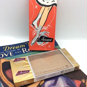 May include: Vintage hosiery boxes with the brand name "Aristoc". One box features an illustration of a figure skater on a red background. Another box is gold and contains "Corista Rosebeige" hosiery.