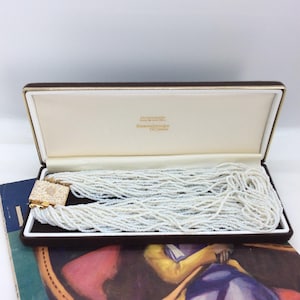 Collana vintage con perline di semi a più fili nella scatola originale