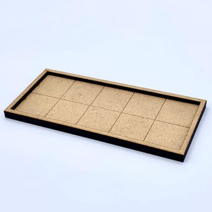 May include: A rectangular wooden tray with a grid pattern of ten squares. The tray has a dark brown border and a light brown interior. The item is set against a white background.