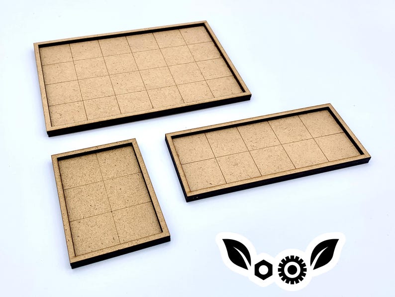 May include: Three wooden game board trays with grid patterns. The trays are rectangular with dark brown edges and a light brown interior. The sizes vary, with one large and two smaller trays. The background is white.