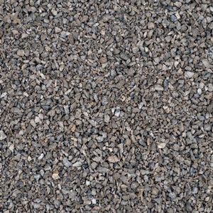 May include: A close-up view of a surface covered in small, gray gravel. The gravel is tightly packed together, creating a uniform texture.