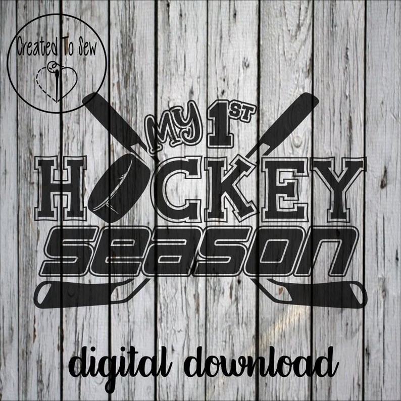 May include: Black and white graphic design featuring the text "My 1st Hockey Season" and two crossed hockey sticks. The text is in a bold, blocky font. The graphic is on a white wood background.