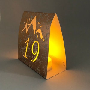 Mountain Table Numbers are made from Copper Mercury Glass or white card stock. These Wedding Luminaries set the rustic western mood. You add a tea light and the romantic glow begins!