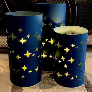 Star Luminary Centerpiece  (set of 3 Luminaries) is made from Card Stock to use with battery candles (not included). Black or Navy. Reusable