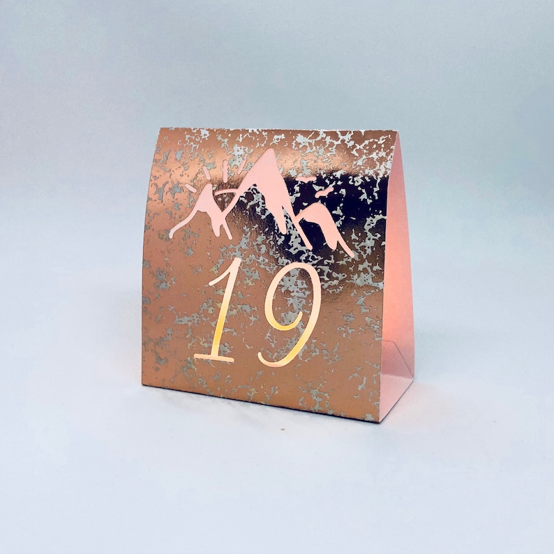 Mountain Table Numbers are made from Copper Mercury Glass or white card stock. These Wedding Luminaries set the rustic western mood.