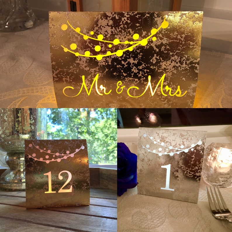 String of Lights Table Numbers are made with mercury style foil cardstock and sheer vellum paper so your battery tea lights can shine through (tea lights not included.) 
Color choices include COPPER, ROSE GOLD, GOLD, SILVER, or MIX & MATCH