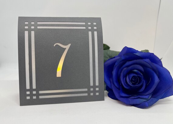 Modern Frame TABLE NUMBER Luminaries are made from card stock with the design cut out so your battery tea lights can shine through!