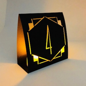 ART DECO Table Number LUMINARIES are made with sturdy card stock and sheer vellum paper. The numbers and modern design are cut out  so your battery tea lights can shine through.The glowing numbers make it easy for guests to find their table.
