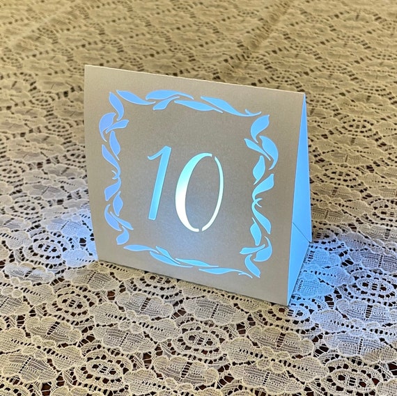 Frame of Leaves table number luminaries for weddings and events • Silver Mercury Glass, Pearl, Blush or Navy card stock.