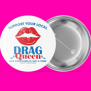 May include: White button with a red lip design and the text "Support Your Local Drag Queen. Self Expression Is Not A Crime." The button has a silver back.
