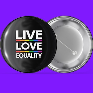 May include: A black button with a rainbow stripe and the text "LIVE LOVE EQUALITY" in white.