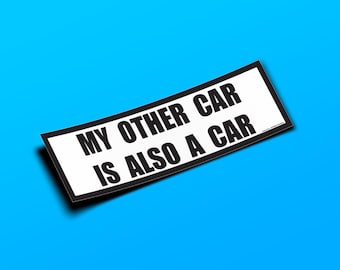 May include: A white sticker with black text that reads "My other car is also a car".