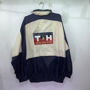 May include: A blue, white, and red windbreaker jacket with the text "T&H Sailing Gear 44-840" on the back.