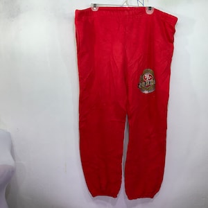May include: Red sweatpants with a gold and black San Francisco 49ers logo on the left leg.