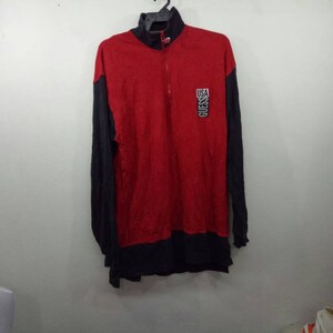 May include: Red and black long-sleeved shirt with a zippered neck and a black and white "USA GUESS" logo on the front.