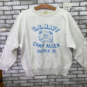 May include: A gray sweatshirt with a blue graphic print of a navy anchor and the text "U.S. Navy Camp Allen Norfolk, VA."