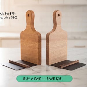 two wooden cutting boards placed on a marble countertop, with a price tag below them.